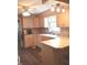 Updated kitchen offers wooden cabinets and countertops, a stainless steel sink, and hard wood flooring at 3115 E 400 S, Anderson, IN 46017