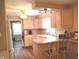Bright kitchen features wood cabinets and countertops with an eat-in bar and stainless steel sink at 3115 E 400 S, Anderson, IN 46017