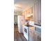 Traditional kitchen features white appliances, cabinets, countertops, and dark hard wood flooring at 3115 E 400 S, Anderson, IN 46017