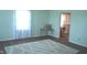 The sunlit living room is bright and airy, complete with an area rug and hard wood floors at 3115 E 400 S, Anderson, IN 46017