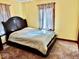 A king-size bed is placed in a cozy bedroom with soft, neutral lighting and natural light at 313 S Brittain Ave, Muncie, IN 47303