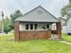 Charming single-story home with brick foundation and inviting front porch at 313 S Brittain Ave, Muncie, IN 47303
