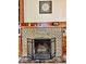 Cozy fireplace with decorative tile surround and wood mantel at 313 S Brittain Ave, Muncie, IN 47303