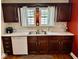 Functional kitchen showcasing dark wood cabinetry, a bright window, and modern appliances at 313 S Brittain Ave, Muncie, IN 47303
