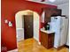 Kitchen featuring red walls, white fridge, dark cabinets and beautiful wood floors at 313 S Brittain Ave, Muncie, IN 47303