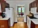 Cozy kitchen with hardwood floors and a view into the adjacent dining room at 313 S Brittain Ave, Muncie, IN 47303