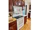 Cozy kitchen with wood cabinets, white appliances and plenty of counter space for easy cooking at 313 S Brittain Ave, Muncie, IN 47303