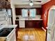 Well-lit kitchen with dark cabinets, white countertops, and hardwood flooring at 313 S Brittain Ave, Muncie, IN 47303