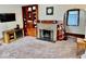 Inviting living room showcasing a fireplace, built-in shelves and lots of natural light at 313 S Brittain Ave, Muncie, IN 47303