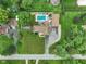 Aerial view of a home with a swimming pool, patio area, and beautifully landscaped yard at 3707 E Wilson Dr, Mooresville, IN 46158