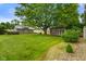 A sprawling backyard features well-manicured grass, mature trees, and two storage sheds at 3707 E Wilson Dr, Mooresville, IN 46158