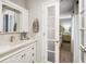 Well-lit bathroom has an undermount sink with a marble countertop, plus access to the bedroom at 3707 E Wilson Dr, Mooresville, IN 46158
