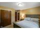 This bedroom includes closet space, a nightstand with a lamp, and neutral carpet at 3707 E Wilson Dr, Mooresville, IN 46158