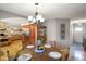 Cozy dining room with wood table, chandelier, and view into the living spaces, creating an inviting atmosphere at 3707 E Wilson Dr, Mooresville, IN 46158