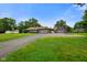 A charming ranch home featuring an attached and detached garage with a sprawling green lawn at 3707 E Wilson Dr, Mooresville, IN 46158