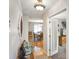 Hallway featuring wood floors and a decorative light fixture leading to a dining room and living room at 3707 E Wilson Dr, Mooresville, IN 46158