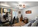 Relaxing home office with ceiling fan, lots of light, and a comfortable couch for breaks at 3707 E Wilson Dr, Mooresville, IN 46158