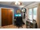 Home office with dual monitors, custom shelving, natural light, and blue accent wall at 3707 E Wilson Dr, Mooresville, IN 46158