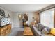 Living room with a comfortable gray sofa, rustic wood furniture, and a light gray wall color at 3707 E Wilson Dr, Mooresville, IN 46158