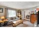 Comfortable living room with neutral tones, a plush sofa, and an open doorway at 3707 E Wilson Dr, Mooresville, IN 46158