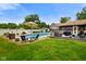 Backyard oasis with a pool, slide, patio, and lush green lawn for outdoor enjoyment at 3707 E Wilson Dr, Mooresville, IN 46158