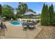 Backyard pool area features a pool with a slide and outdoor dining under the umbrellas at 3707 E Wilson Dr, Mooresville, IN 46158