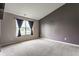 Spacious bedroom featuring neutral carpeting, grey accent wall, and natural light at 3872 Dusty Sands Rd, Whitestown, IN 46075