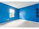 Comfortable bedroom with blue walls and large window offers natural light at 3872 Dusty Sands Rd, Whitestown, IN 46075