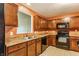 Functional kitchen features plenty of cabinet space, appliances, and a window at 3872 Dusty Sands Rd, Whitestown, IN 46075