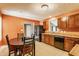 Functional kitchen featuring appliances, wood cabinetry, and a table with chairs at 3872 Dusty Sands Rd, Whitestown, IN 46075