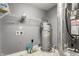 Functional laundry area featuring shelving, water heater, and utility connections at 3872 Dusty Sands Rd, Whitestown, IN 46075