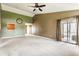 Open-concept living room featuring a ceiling fan, sliding glass doors, and a pass-through to the kitchen at 3872 Dusty Sands Rd, Whitestown, IN 46075