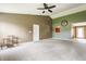 Large living room features a ceiling fan, neutral carpet and access to other areas of the home at 3872 Dusty Sands Rd, Whitestown, IN 46075
