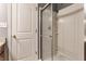 Tiled shower features modern glass doors and a convenient built-in shelving unit at 3872 Dusty Sands Rd, Whitestown, IN 46075