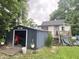 View of the backyard featuring a shed and house with small deck with stairs at 403 N College Ave, Greencastle, IN 46135