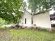 Backyard view of the property with lush trees, window, and an above ground swimming pool in the distance at 403 N College Ave, Greencastle, IN 46135