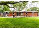 Back view of a brick home with a covered patio, trampoline, and large yard at 4191 N Graham Rd, Whiteland, IN 46184