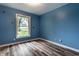 Bedroom features blue walls and light wood-look floors at 4191 N Graham Rd, Whiteland, IN 46184