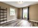 Bedroom with tan walls, light wood-look floors, and natural light at 4191 N Graham Rd, Whiteland, IN 46184