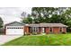 Charming single-story brick home with a well-manicured lawn, tidy landscaping, and an attached two-car garage at 4191 N Graham Rd, Whiteland, IN 46184