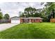 Well maintained single-story brick home featuring a manicured front lawn with tidy landscaping and an attached two-car garage at 4191 N Graham Rd, Whiteland, IN 46184