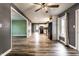 Bright and airy living room offering wood-look floors, a modern ceiling fan, and seamless transition to kitchen at 4191 N Graham Rd, Whiteland, IN 46184