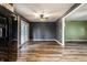 Open-concept view from the kitchen into a spacious living area with wood-look flooring and sliding door access to outdoor space at 4191 N Graham Rd, Whiteland, IN 46184