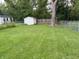 Spacious backyard with a storage shed, chain link fence and mature shade tree at 4310 Crittenden Ave, Indianapolis, IN 46205