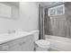 Updated bathroom features gray shower tile and modern vanity at 4310 Crittenden Ave, Indianapolis, IN 46205