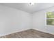 Bright bedroom showing neutral walls, baseboard trim, and wood-look laminate flooring at 4310 Crittenden Ave, Indianapolis, IN 46205