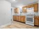 Modern kitchen features wood cabinets, granite counters, and white appliances at 4310 Crittenden Ave, Indianapolis, IN 46205