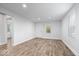 Bright living room featuring modern wood-look flooring, fresh white walls, and recessed lighting at 4310 Crittenden Ave, Indianapolis, IN 46205