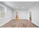 Open living room showcases modern wood-look floors and leads into the kitchen area at 4310 Crittenden Ave, Indianapolis, IN 46205