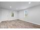 Bright living room featuring modern wood-look flooring, fresh white walls, and recessed lighting at 4310 Crittenden Ave, Indianapolis, IN 46205